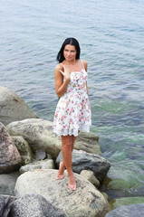A young and beautiful woman near the sea