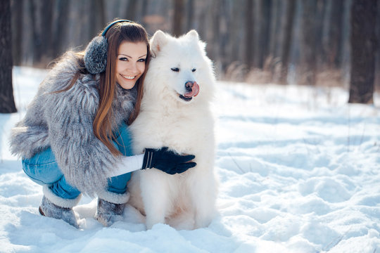 Happy Woman With Dog In Winter Forest