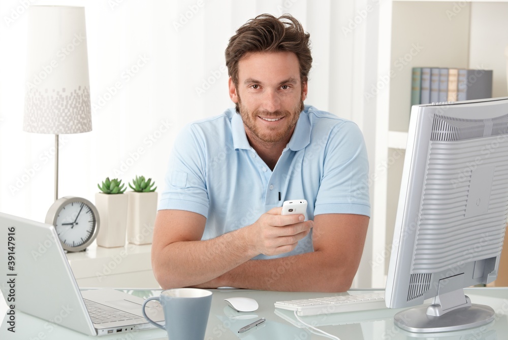 Sticker smiling man at desk with mobile phone