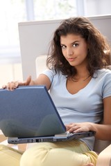 Beautiful girl using computer at home