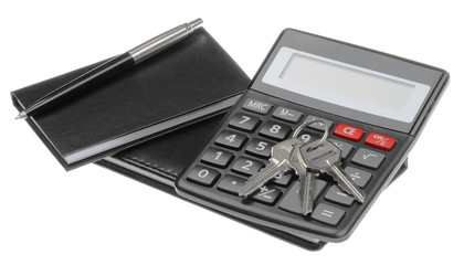 notebook, pen, key and black calculator