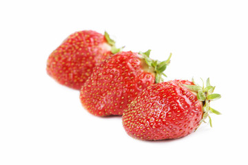 Three strawberries on a white background