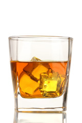 Glass of scotch whiskey and ice isolated on white