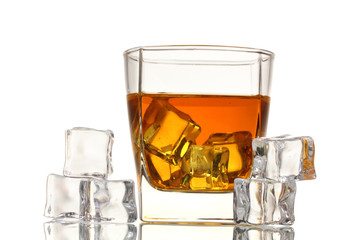 Glass of scotch whiskey and ice isolated on white