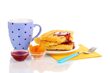 Tasty waffles with jam on plate isolated on white