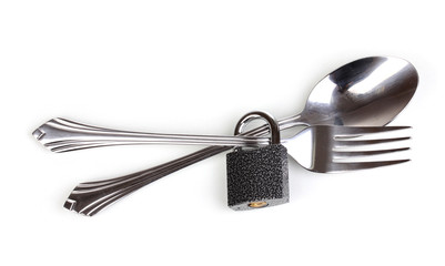 Fork and spoon with padlock isolated on white
