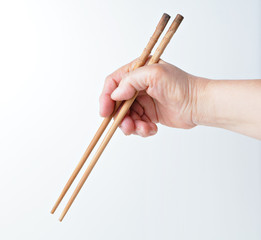 hand using chopsticks
