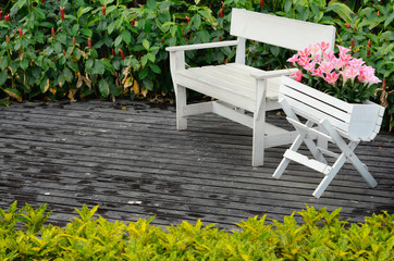 White wood chair on floor in garden