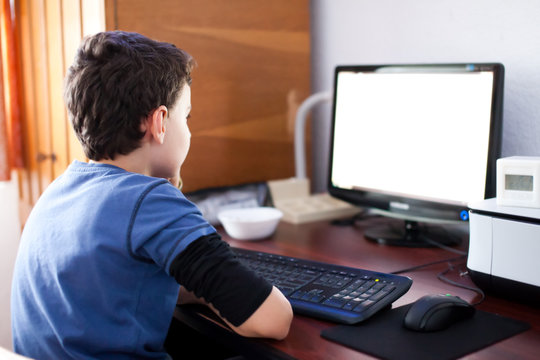 Boy Reading On Computer Screen