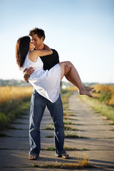 Young Man Caring Young Woman in Arms