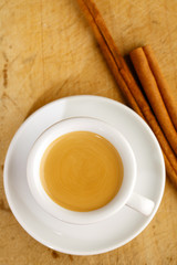 espresso coffee in thick white cup with Cinnamon sticks , on woo