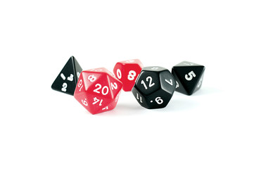 Photo of red and black multi-sided dice, on white