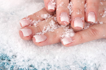 Fototapeta premium hands with snow and snowflakes closeup
