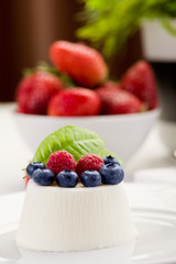 Panna cotta with Berries on white table