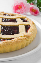 Breakfast with jam tart in white dish.