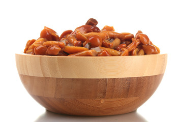 Marinated mushrooms in wooden bowl isolated on white
