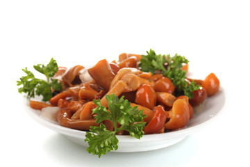 Marinated mushrooms in white saucer isolated on white