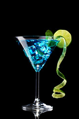 Blue cocktail in glass on black background
