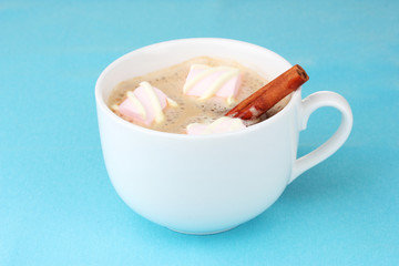 Cup of cappucino with marshmallows and cinnamon
