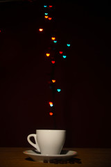 cup of coffee on wooden table on bright bokeh backdground