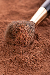 Cosmetic background. Makeup brush and powder