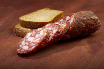 Close-up traditional  sausage salami on wooden board