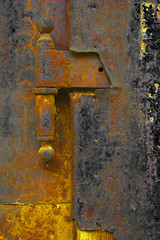 Close-up of the hinge of the old rusty iron door