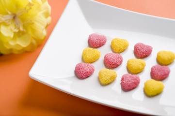Heart candy, orange background, flower, front focus