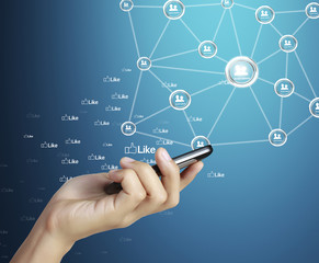 Hand holding mobile phone with social network,blue background