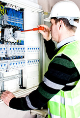 Electrician checking a fuse box - 39179542