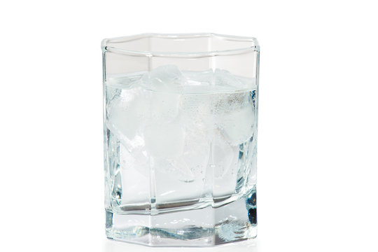 Glass of water and ice on a white background