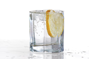 Glass of water, ice and slice of fresh lemon