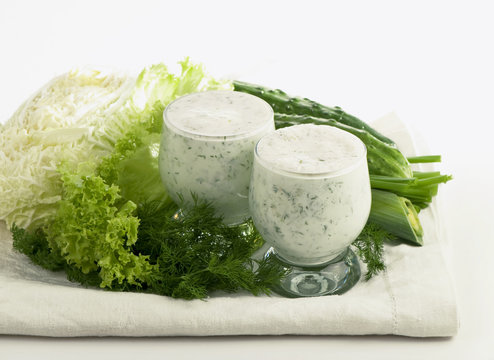 Dairy-grassy drink, branch of parsley cucumber and salad leaves