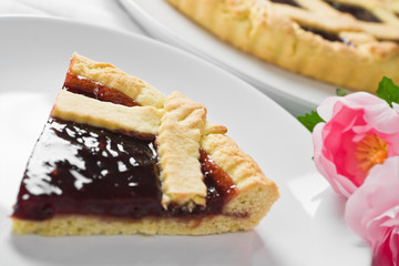 Breakfast with jam tart in white dish.