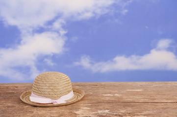 Fototapeta na wymiar bowler straw hat lying on an old wooden table