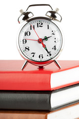 Alarm clock and colourful books