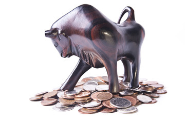 A strong, triumphant bull atop a pile of coins, signifying an op