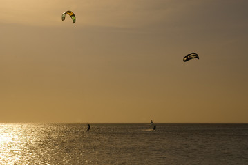 Kitesurfers silhouettes against sunset