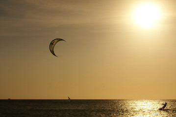 Kitesurfer's silhouette against the sun