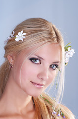 Portrait of smiling blonde woman with flowers in her hair