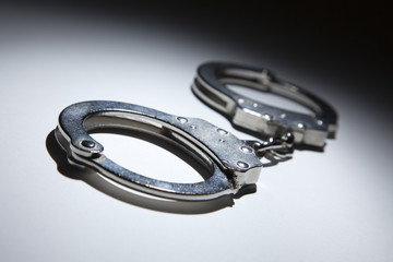 Abstract Pair of Handcuffs Under Spot Light