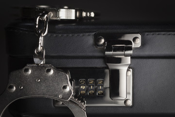 Pair of Handcuffs on Briefcase with 911 on Lock