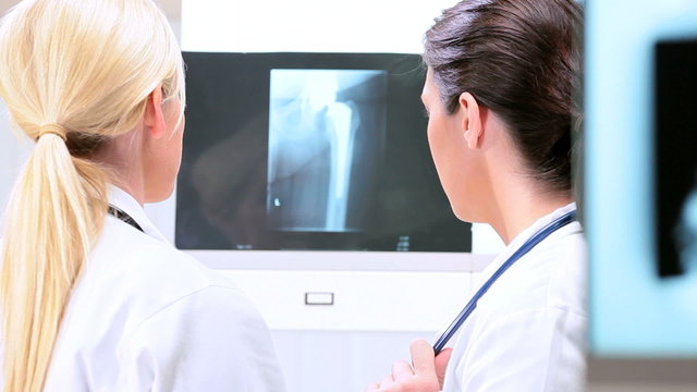 Female Doctors Inspecting X-Ray Results