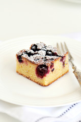 White chocolate brownie with forest fruit in a white dish