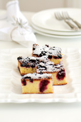 White chocolate brownie with forest fruit in a white dish