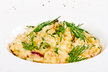 photo of delicious risotto with seafood and dill on it