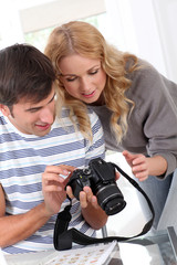 Couple looking at picture on camera screen