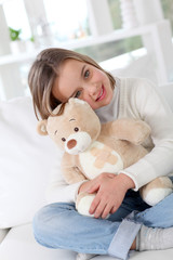 Sick little girl hugging sick teddy bear