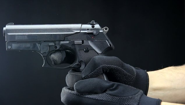 handgun close up over black background