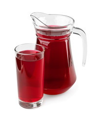 Pitcher and glass of fruit juice on white background